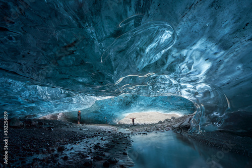 Tourists exploring an Ice Cave in Breiðármerkurjökull outlet glacier, Vatnajökull National Park, Southeast Iceland. 