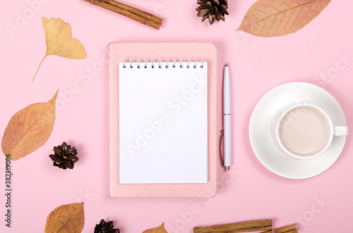 Autumn background with coffee, cinnamon and leaves on light background