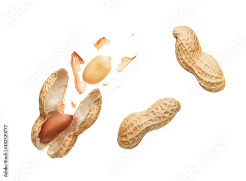 Opened shell peanut and unpeeled peanuts over white background