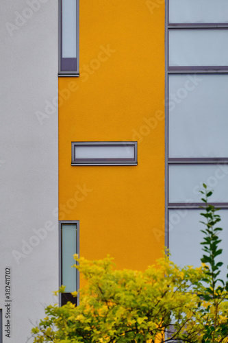 The modern yellow and white facade of the apartment building in Finland. The modern nordic architecture.