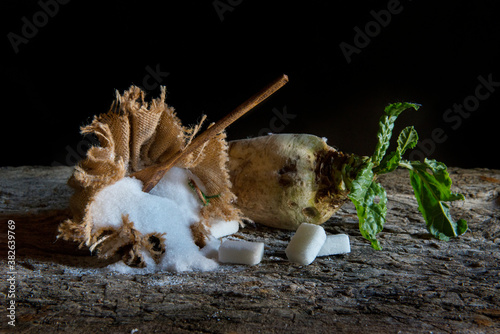 sugar beet and white sugar on an old wooden table