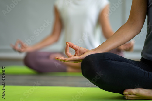 caucasian woman doing yoga exercise workout on yoga mat in fitness center
