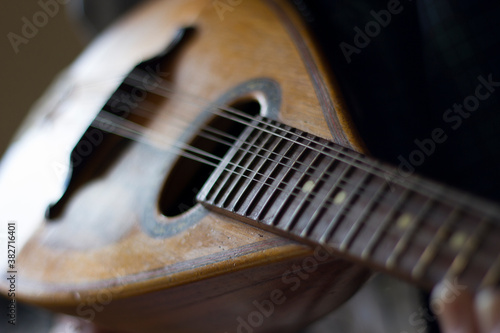 Old hands playing a mandolin