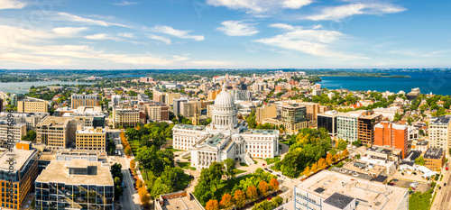 Wisconsin State Capitol and Madison skyline panorama. The Wisconsin State Capitol, houses both chambers of the Wisconsin legislature, Supreme Court and the Office of the Governor.