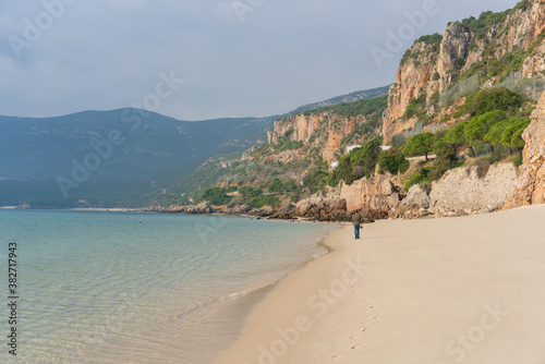 Man walking in Figueirinha beach in Arrabida park