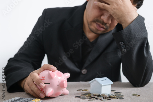 Businessman is stressed out of losing their jobs and insufficient savings to pay for a mortgage.