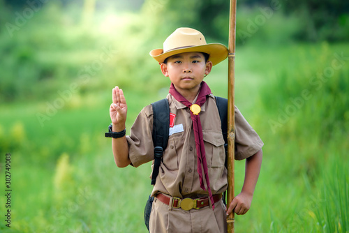 Boy Scout students congratulate Boy Scouts during outdoor event.