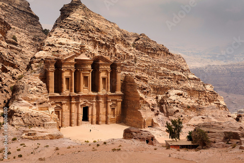 El Deir - The Monastery at Petra, Jordan with a person standing in front.