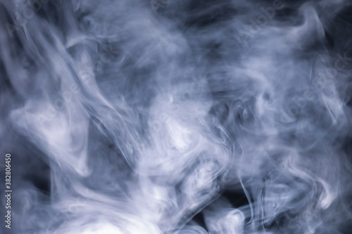 White cigarette smoke texture in a black background. 