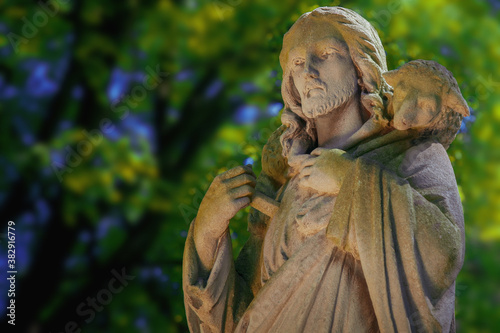 Ancient statue of Good Shepherd Jesus Christ with the lost sheep on his shoulders.