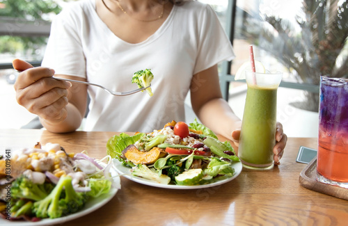 Selective focus of woman with Broccoli and salad which she make a Intermittent fasting with a Healthy food of salad and detox drink ,Healthy lifestyle Concept.