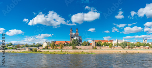 Panoramic view over downtown of Magdeburg, old town, Elbe river and Magnificent Cathedral at early Autumn, Germany, at sunny day and clear blue sky with funny clouds.