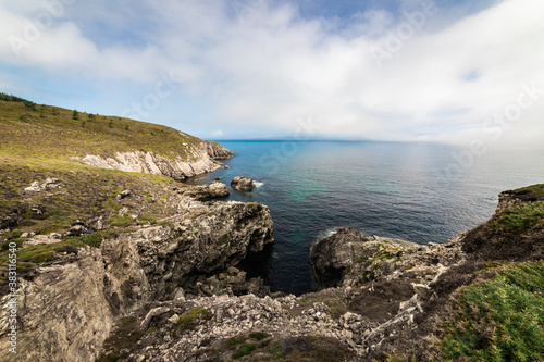 landscape of the coast of Galicia, Spain. You can see the cliffs and the sea on a sunny day with clouds 