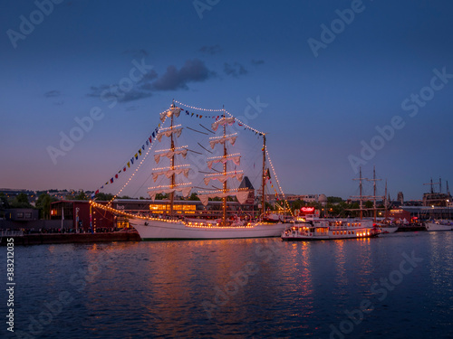 By night, aAerial view of Armada exhibition greatest sailboats at Rouen dock on Seine river. International meeting for biggest old schooners and frigates ship in world.
