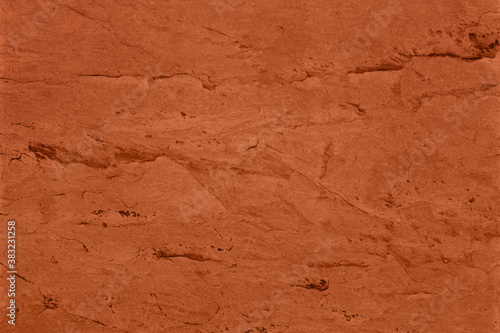 Saturated dark orange brown colored low contrast Concrete textured background with roughness and irregularities. 2021, 2022 color trend.