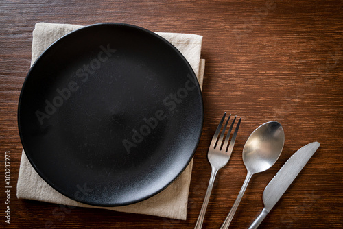 empty plate or dish with knife, fork and spoon