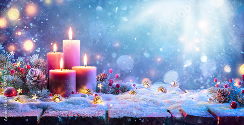 Advent - Four Purple Candles With Christmas Ornament In Shiny Night