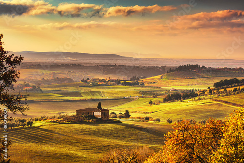 Maremma, rural sunset landscape. Countryside old farm and green field. Tuscany, Italy.
