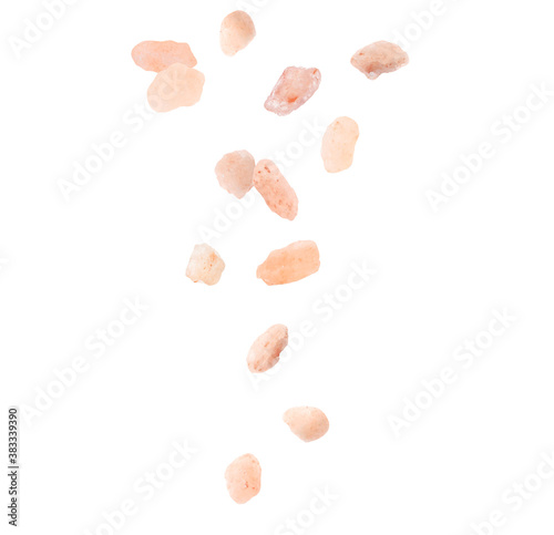 Pink himalayan salt falling on white background