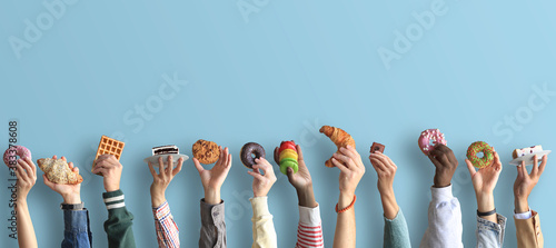 People are holding different desserts in their hands. The concept of food and sweets.