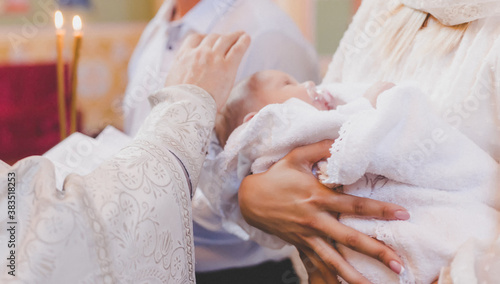 The sacrament of the baptism of a child. Selective focus.