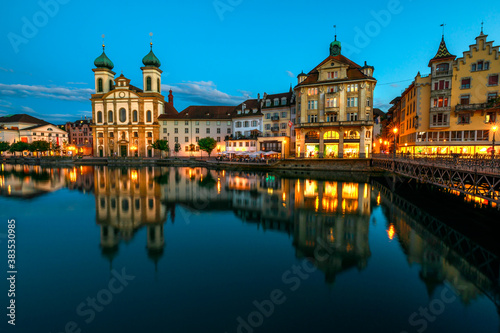 Lucerne cityscape by twilight and Lake Lucerne, Vierwaldstatersee, Canton of Lucerne in Central Switzerland. Jesuitenkirche or Jesuit Church reflects on Reuss river. Famous landmark of historical city