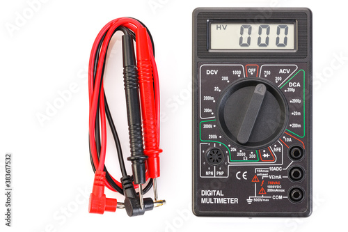 Digital electrical tester multimeter in black case isolated on white background. Digital multimeters have a numeric display, can measure voltage, current and resistance. Close-up.