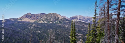 Lake Cuberant hiking trail views of ponds, forest and meadows with Bald Mountain Mount Marsell in Uinta Mountains from Pass Lake Trailhead, Utah, United States.