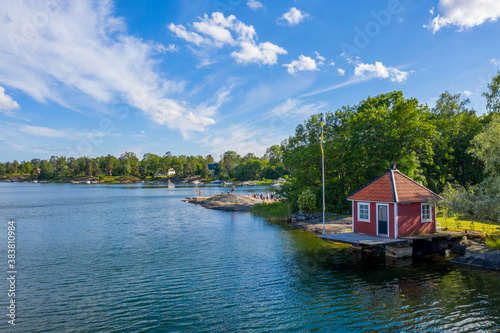 Small red cottage by water in Stockholm archipelago in Sweden