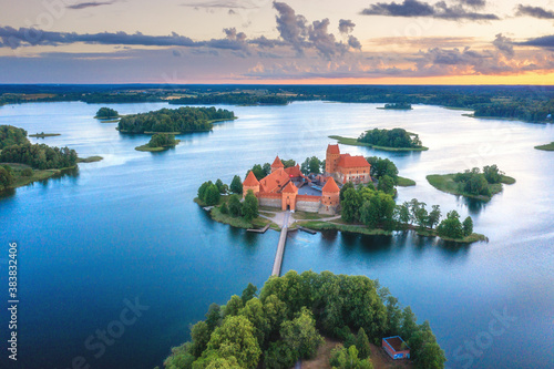 Summer landscape. Aerial view of Trakai castle. Historical sightseeings of Lithuania. Early sunrise. Green islands among of lake. Blue water in lake. 