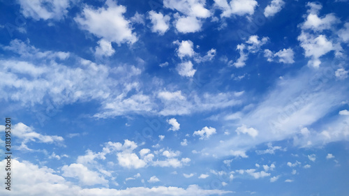 Beautiful blue sky with small white cumulus and large cirrus clouds as natural background