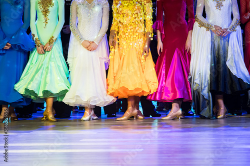 woman in ballroom dresses lined up in a row