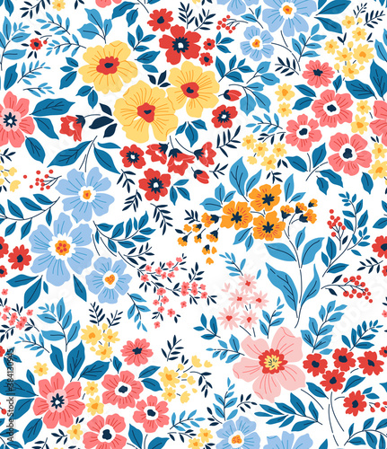 Trendy seamless vector floral pattern. Seamless print made of small multicolored flowers and blue leaves . Summer and spring motifs. White background. Vector illustration.