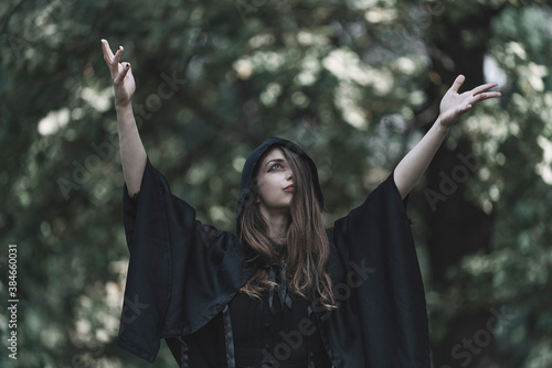 Young witch praying to ancient dark gods