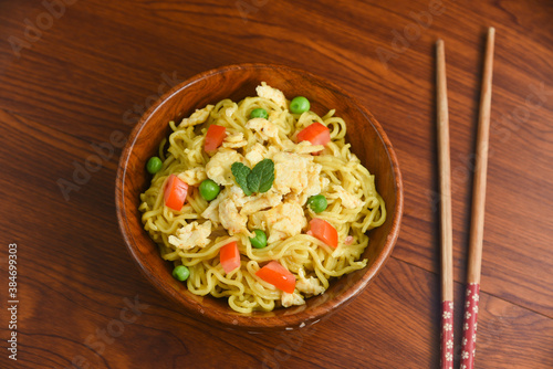 Vegetarian Schezwan Noodles Vegetable Hakka Noodles or Chow Mein in wooden bowl Schezwan Noodles is indo-chinese cuisine hot dish udon noodles Indonesian fried egg noodle. Indian Instant noodles ramen