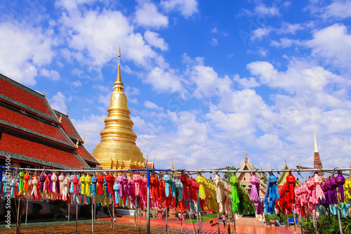 Festival lantern or Colorful lamp hanging on line rope blue sky background , decorations for celebration loy krathong festival in Wat Phra That Hariphunchai woramahawihan lamphun of Thailand