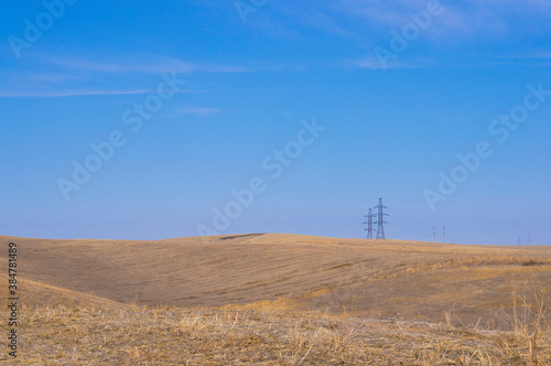 Power lines on the horizon in the steppe.