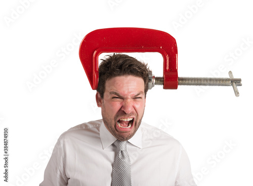 Businessman with a vise on his head. concept of headache