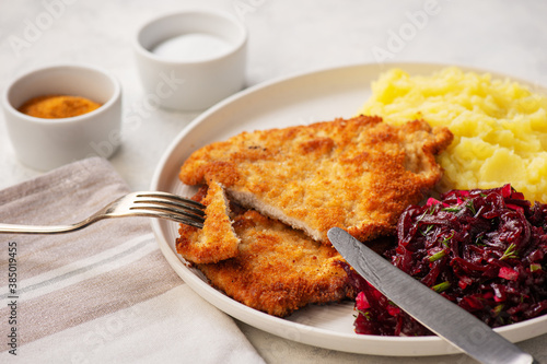 Chop pork cutlets , served with mashed potatoes and beetroot salad.