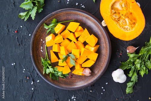 Beautifully chopped pumpkin slices, herbs, and ingredients for the dish. Creative atmospheric decoration