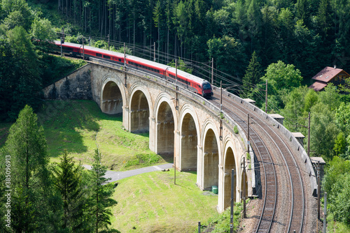 Train on the viaduct over the Adlitzgraben on the Semmering Railway. The Semmering Railway is the oldest mountain railway of Europe and a Unesco World Heritage site.