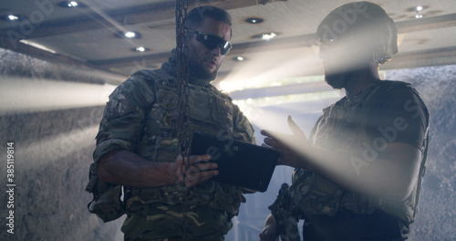 Soldier showing region plan to commander