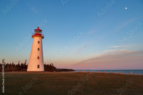 Lighthouse and moon during sunset, Prince Edward Island, Canada.
