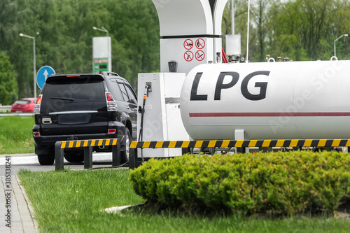 Liquid propane gas station. Black modern SUV car refueling tank with alternative power natural liquefied fuel