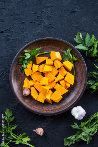 Beautifully chopped pumpkin salad, herbs, and ingredients for the dish. Creative atmospheric decoration