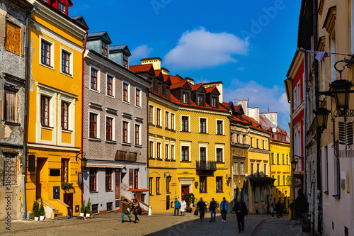 View of traditional colored tenements houses on central streets of Polish city of Lublin in sunny spring day