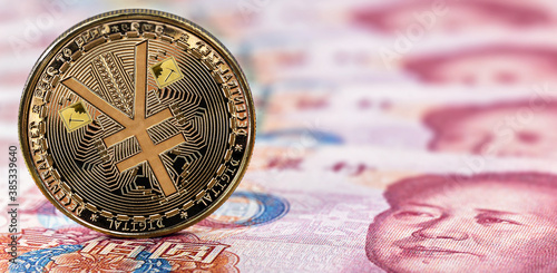 e-RMB gold coin, over 100 yuan banknotes, conceptual image of the digital version of the yuan. Chinese decentralized currency