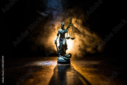 The Statue of Justice - lady justice or Iustitia / Justitia the Roman goddess of Justice on a dark fire background