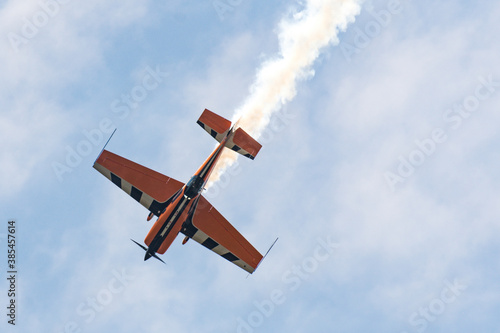 Barcelona, Spain; August 26, 2018: Acrobatic airplane show with white smoke. Extra 330sc