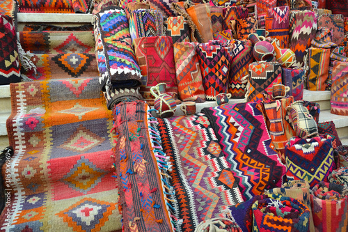 Colorful carpets, blankets and souvenirs exposed on the steps of a bazaar in Erbil, Iraq.